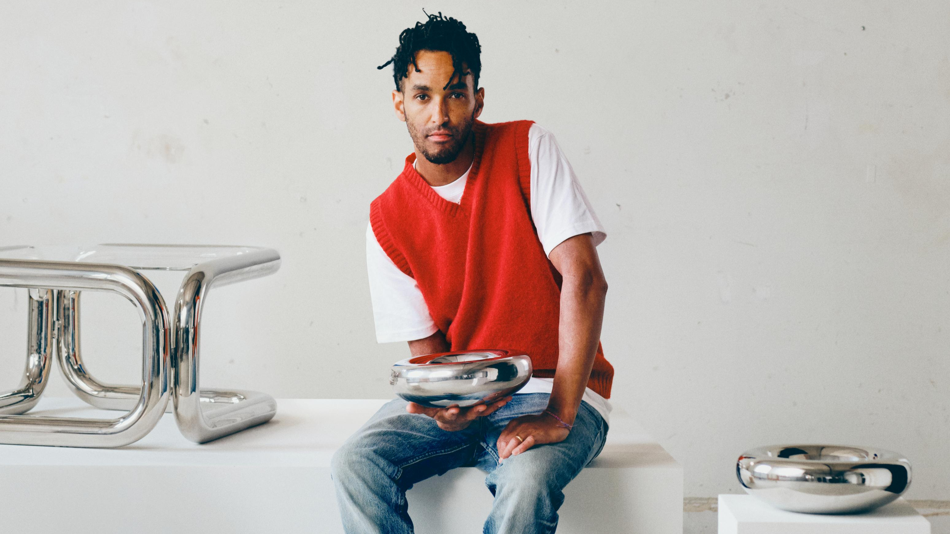 Andu Masebo with the stainless steel objects and furniture he designed for Ikea