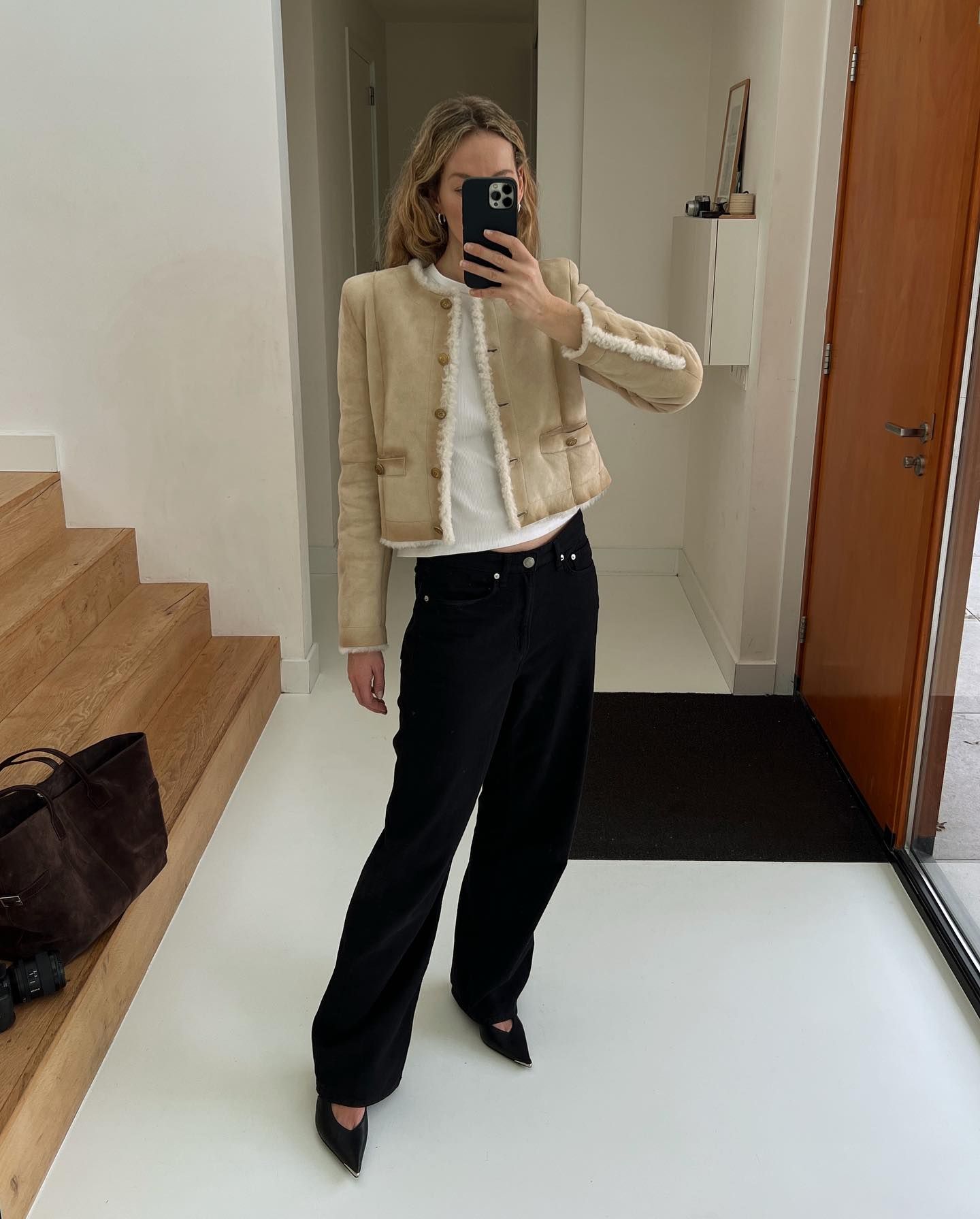 Woman wearing black low-rise jeans and jacket