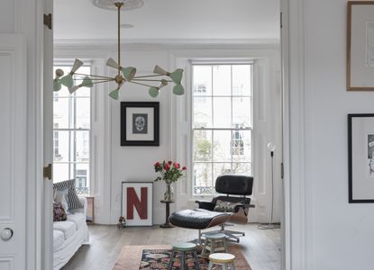 A living room with high ceilings and two large sash windows