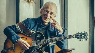 Steve Howe grinning with his acoustic guitar, 2016