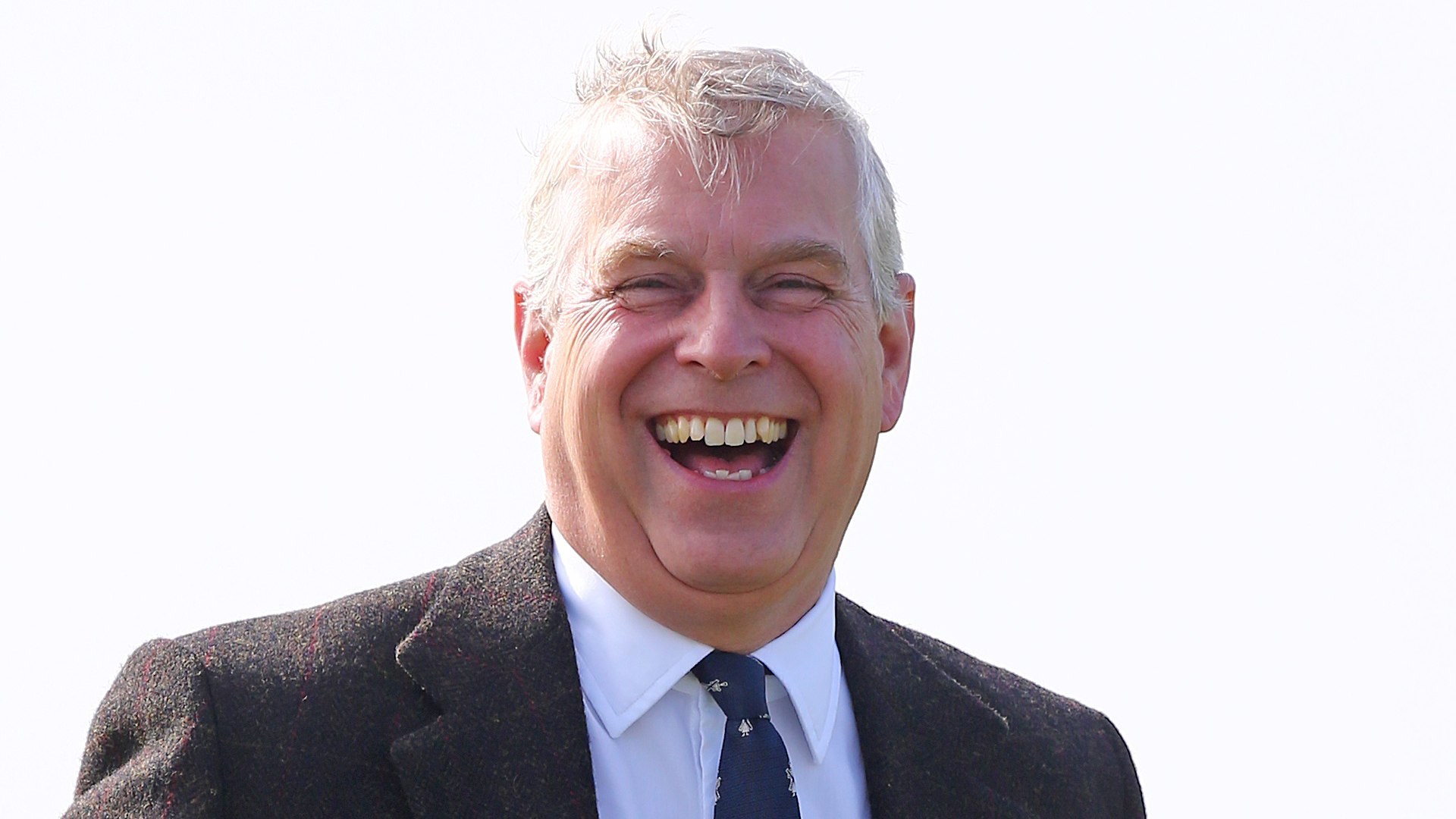 Ex-Prince Andrew laughs while wearing a suit and tie