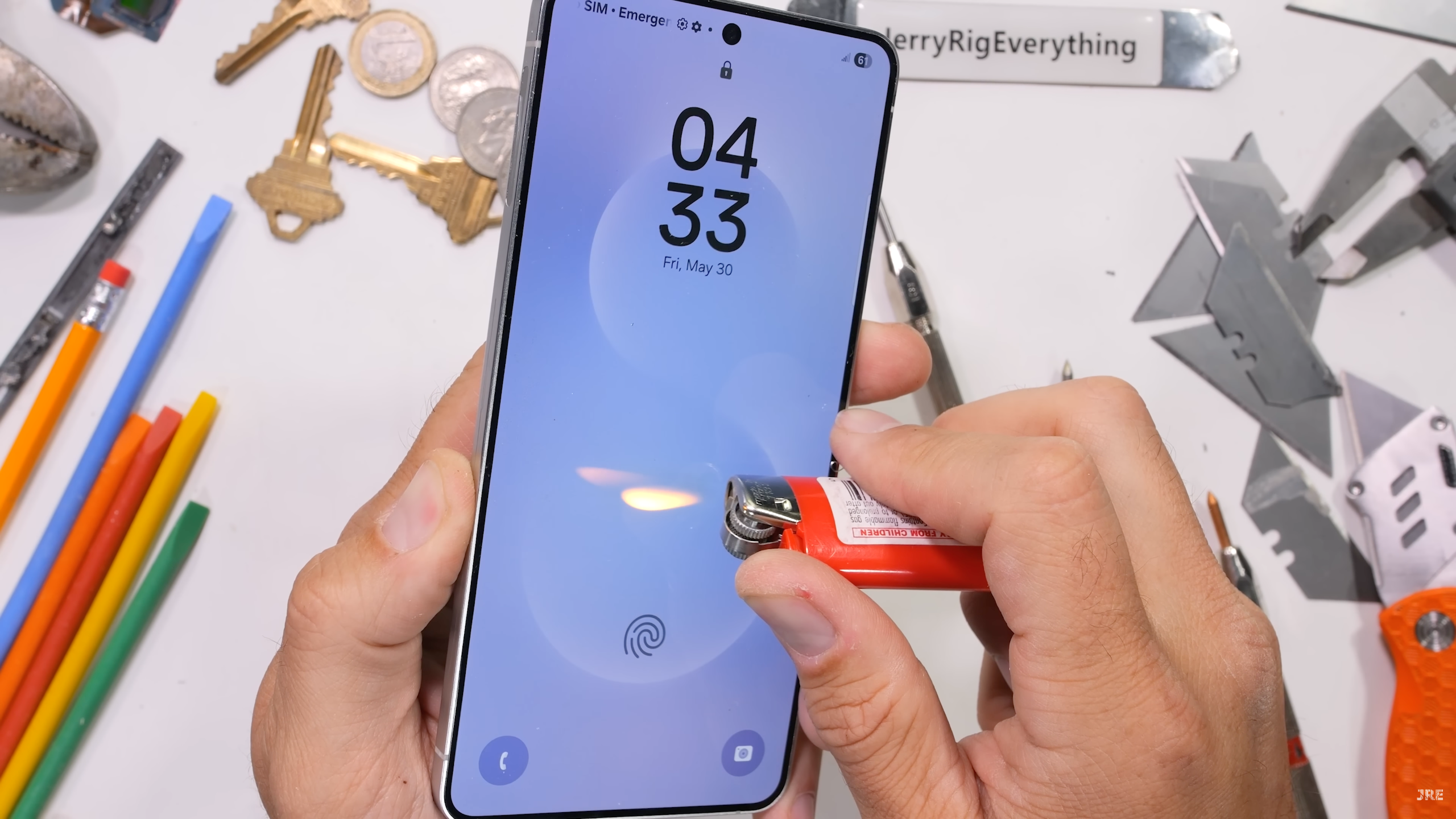 Galaxy S25 Edge durability test by JerryRigEverything, with a lighter being pressed to the phone's screen