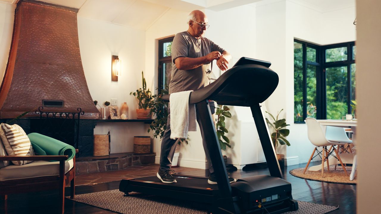 Man walking on treadmill in a domestic setting