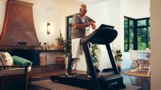 Man walking on treadmill in a domestic setting