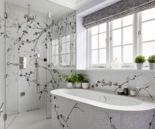 A bathroom with a mosaic mural design