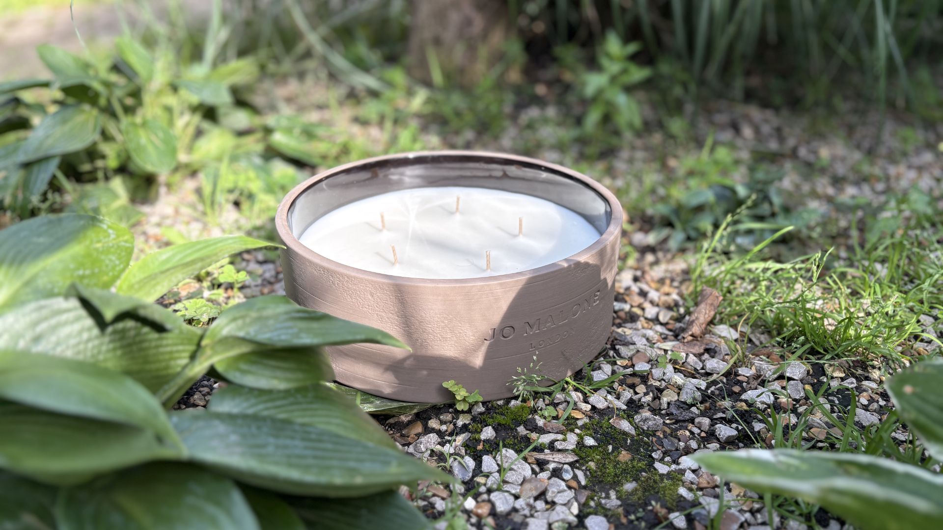 Jo Malone Outdoor Candle on grass outside