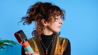 the dyson airwrap ID in teal and terracotta colorway (patina and orange) with a lapis case, with a brush, hairdryer, curling wand attachments