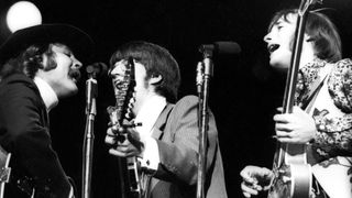 Guitarists Stephen Stills (right) and Richie Furay of the supergroup "Buffalo Springfield" perform onstage at the Monterey Pop Festival, with David Crosby of the Byrds (left)