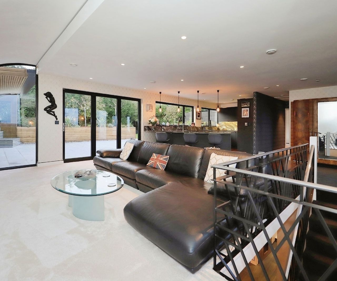 A kitchen dining room with stairs leading downstairs