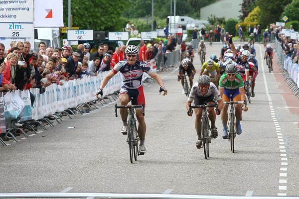 Andre Greipel (Lotto Belisol) raises his arms in victory as he approaches the finish line.