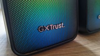 The Trust GXT 611 Wezz RGB speakers pictured on a wooden desk.