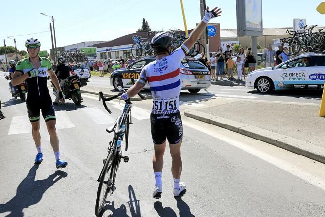 Mark Cavendish (Omega Pharma Quick Step) signals for help after a crash