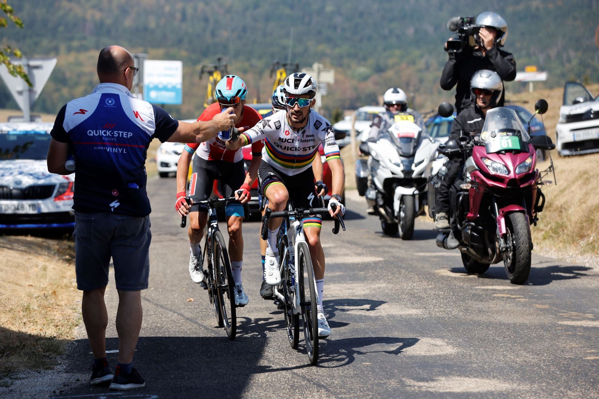Julian Alaphilippe of France and Team Quick-Step - Alpha Vinyl picks bottles from a team soigneur during the 34th Tour de l'Ain 2022 - Stage 3