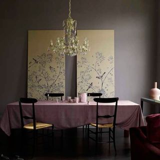 dinning room with grey wall chrome yellow painting chandelier dinning table and chairs
