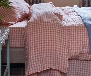 Pink Bloom Gingham Linen Sheet Set on a bed.