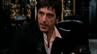 Al Pacino sits during a freak out in Scarface.
