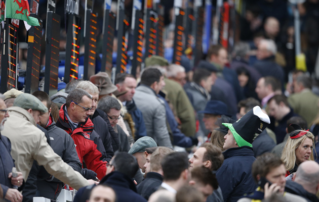 A packed crowd: bustling racegoers place their bets