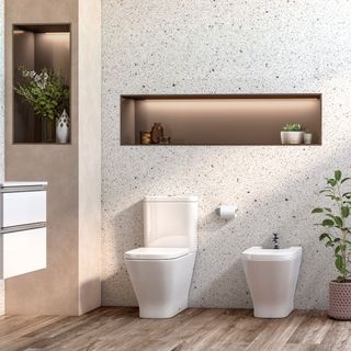 Bathroom with stud wall behind loo and bidet with storage space and lighting