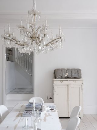 A dining room with an overhead chandelier