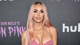 Megan Fox has pink hair and dark roots whilst attending "Machine Gun Kelly's Life In Pink" premiere on June 27, 2022 in New York City.