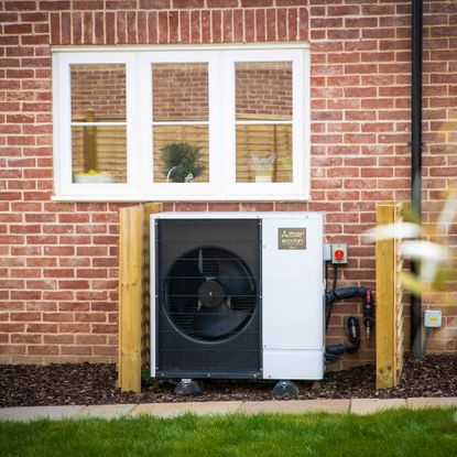 Mitsubishi Electric heat pump on house brick wall