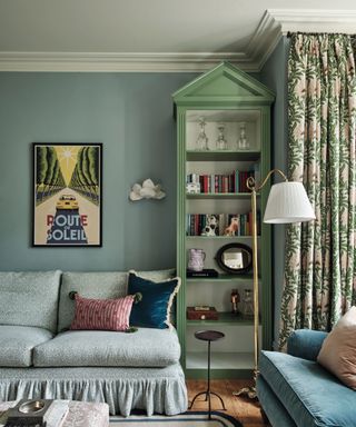 sitting room with blue walls and green painted shelf with arch