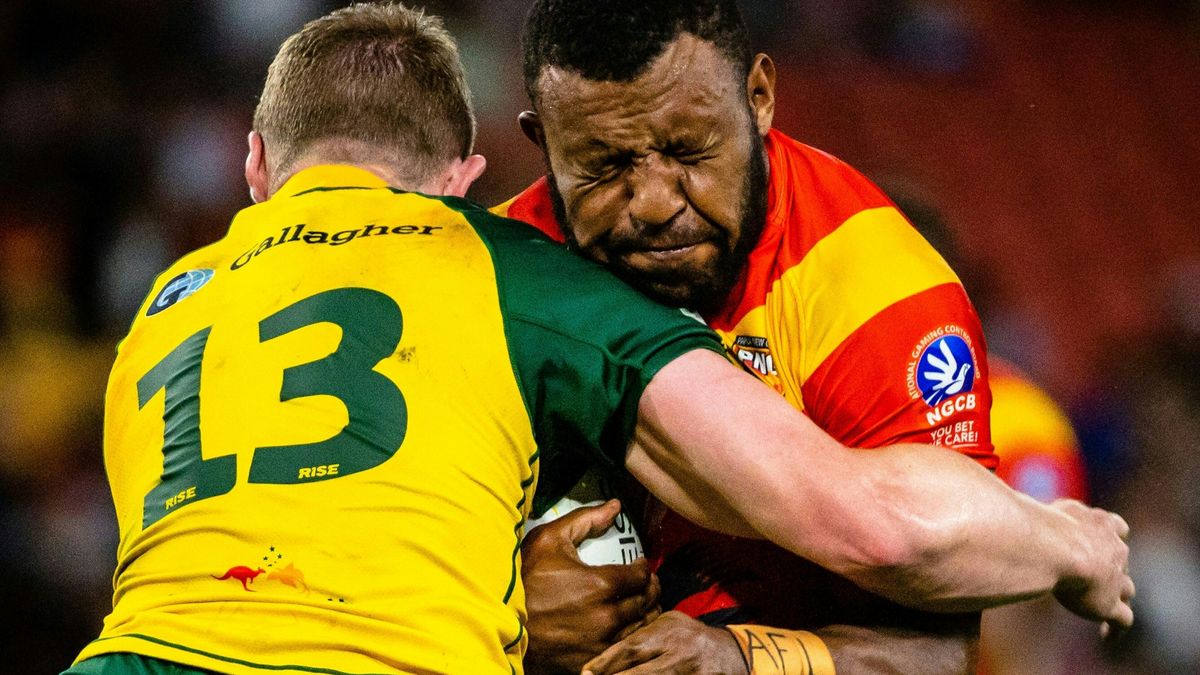 Australia and Papua New Guinea players clash in a rugby league tackle.