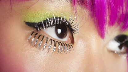 extreme close up of young funky woman's face with false eyelashes