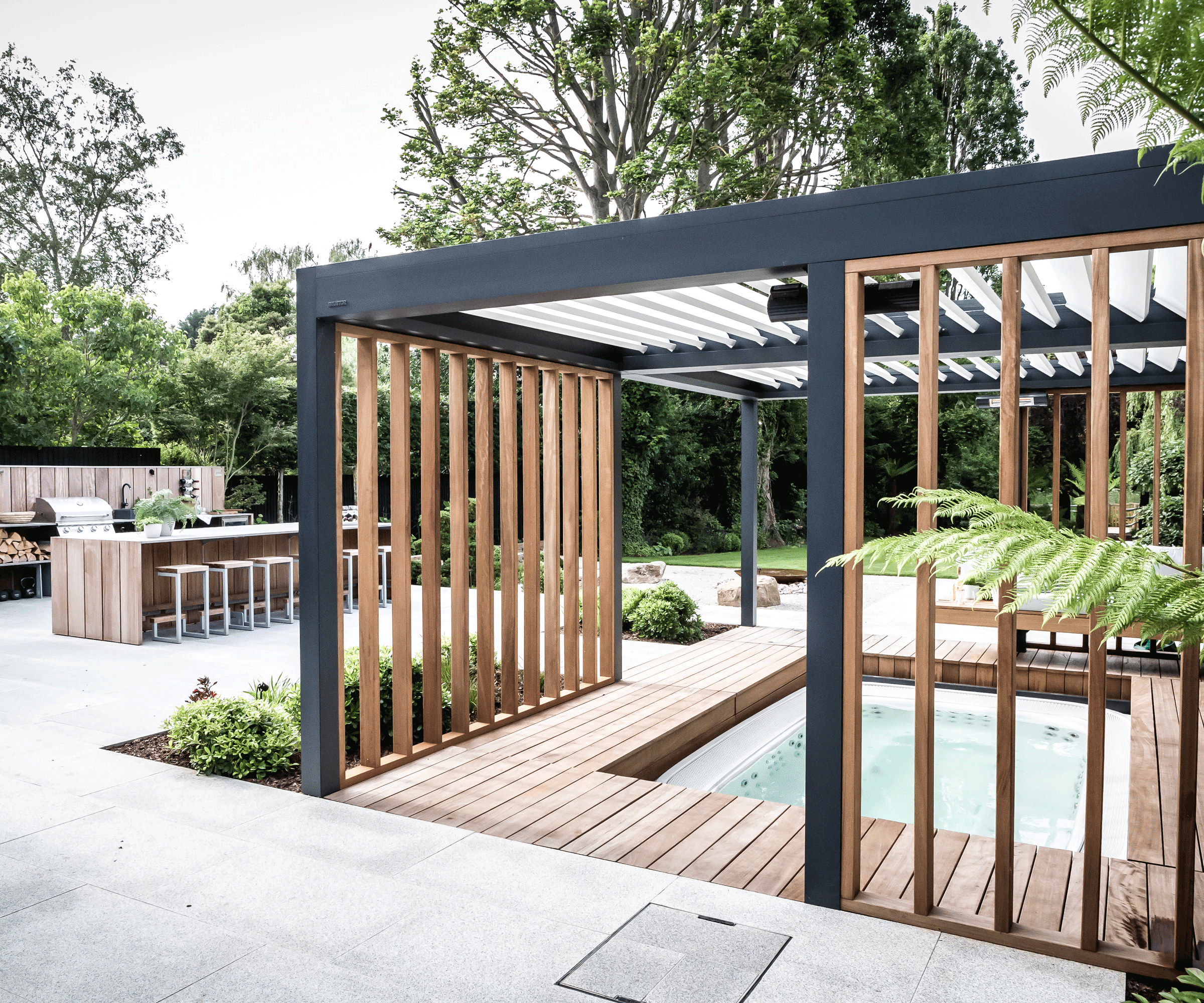 modern garden design with pergola, hot tub and outdoor kitchen