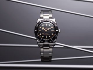 black-dial watch with steel bracelet