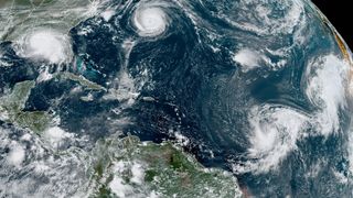 A satellite image shows five tropical cyclones churning in the Atlantic basin on Monday, Sept. 14, 2020. The storms, from left, are Hurricane Sally over the Gulf of Mexico, Hurricane Paulette over Bermuda, the remnants of Tropical Storm Rene, and Tropical Storms Teddy and Vicky.