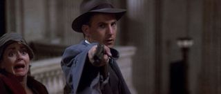 Eliot Ness (Kevin Costner) starts the shooting with a one-handed shotgun blast in