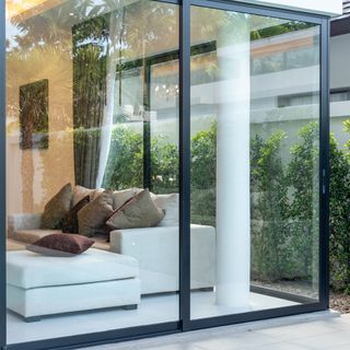 Glass sliding doors on patio with black frame