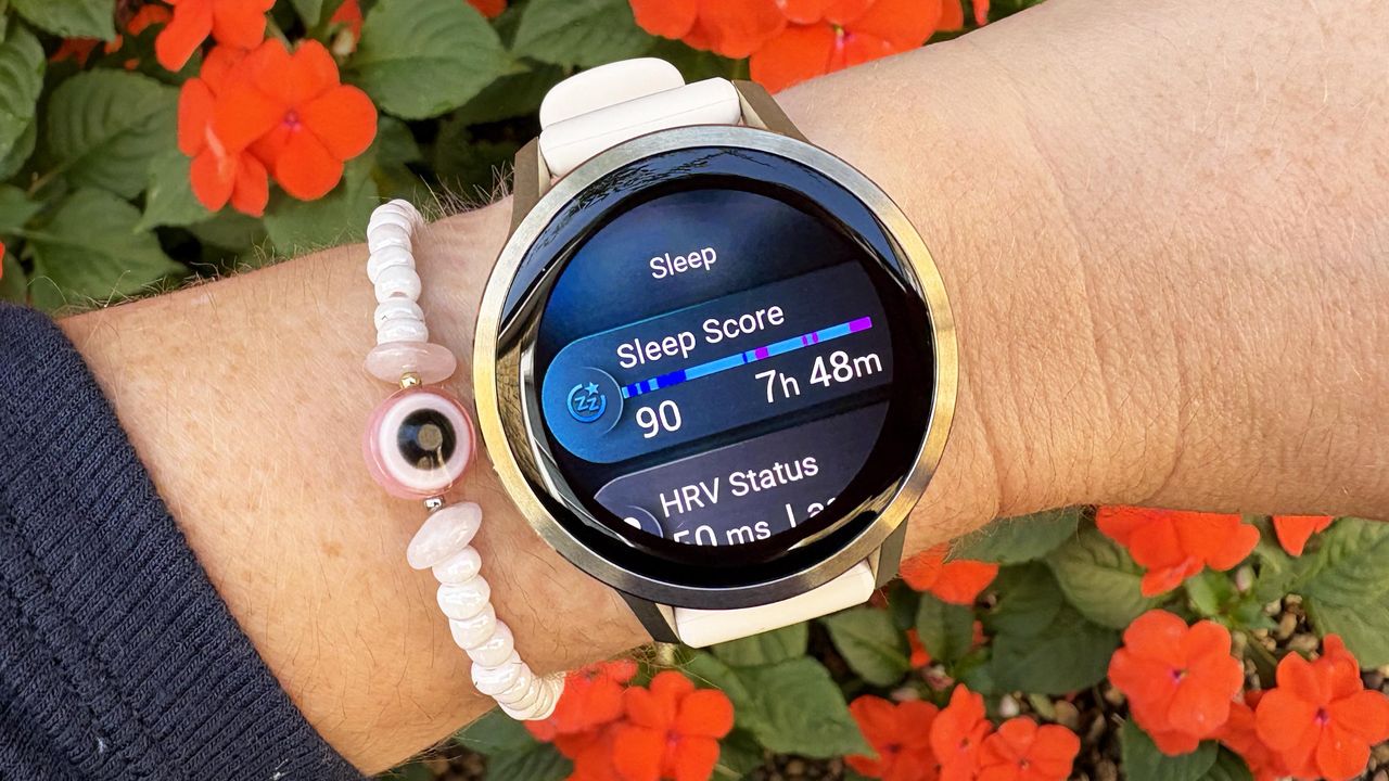 the Garmin Venu 4 in lunar gold on the wrist showing the Sleep Score