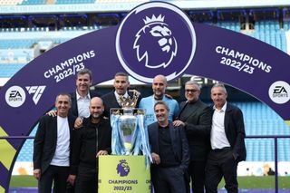 Pep Guardiola the head coach / manager of Manchester City poses with the Premier League trophy and Manchester City / City Football Group board members during the Premier League match between Manchester City and Chelsea FC at Etihad Stadium on May 21, 2023 in Manchester, United Kingdom. (Photo by Matthew Ashton - AMA/Getty Images)