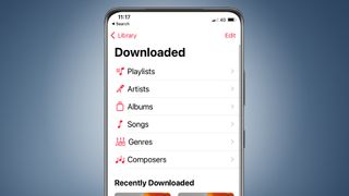 An iPhone on a blue background showing the downloaded section of the Apple Music app