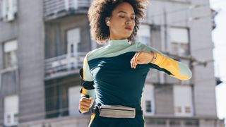 Woman checking sports watch while running