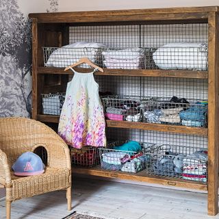 wooden shelve with netted basket kids chair and cloths