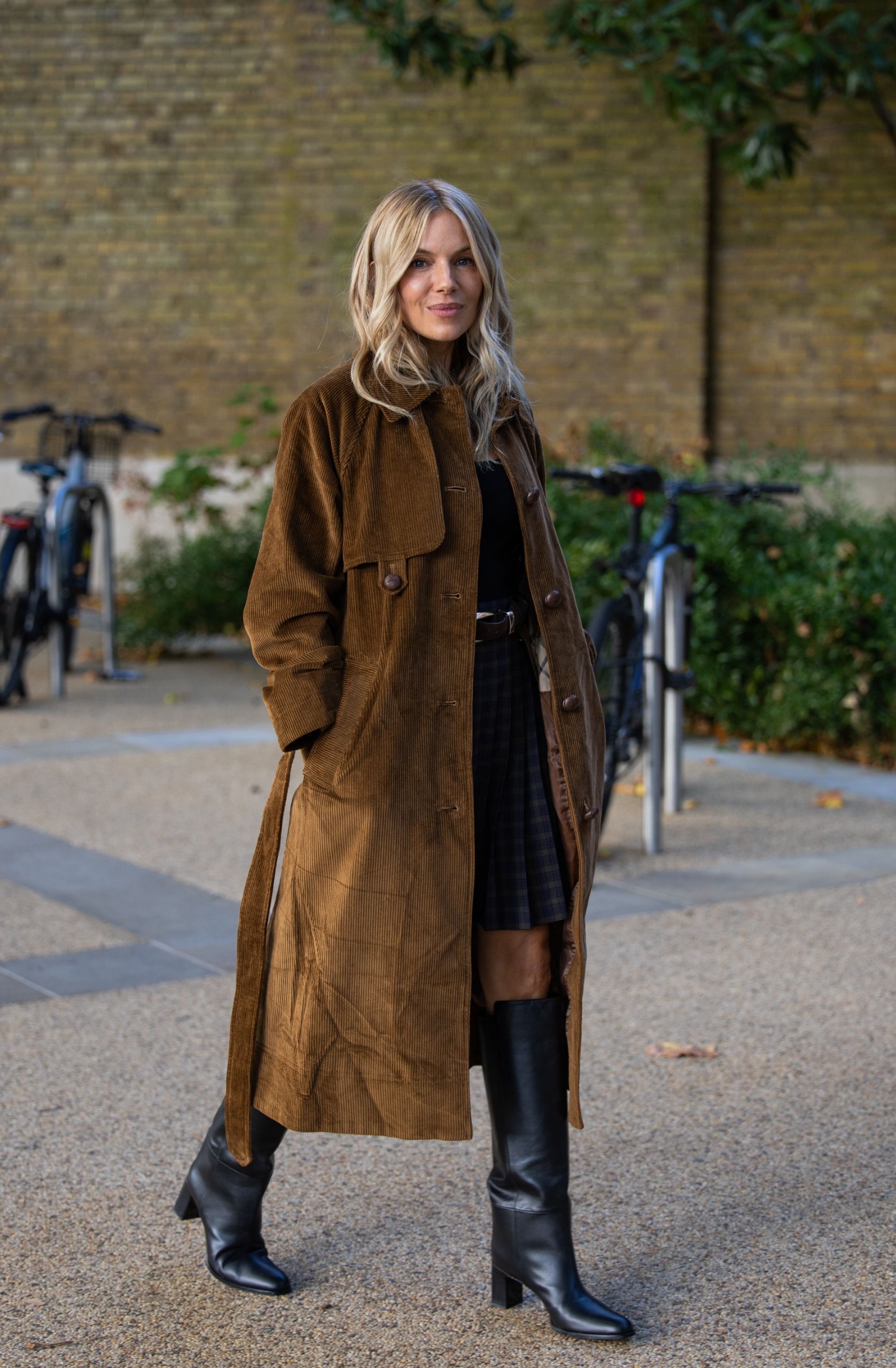 Sienna miller wears a the suede trench coat trend 2026. She is spotted at the Barbour activation.
