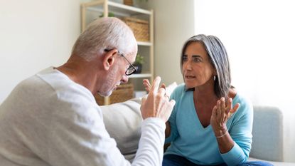 Senior couple arguing on the sofa at home 