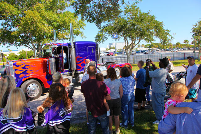 NASA Kennedy Space Center employees and their families gather around &#039;Optimus Prime&#039; in this snapshot taken during a photo opportunity Oct. 8, 2010 after the Transformer cars were used to film scenes of the new &quot;Transformers: The Dark of the Moon&quot; film at