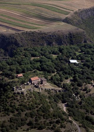 An aerial view of the Dmanisi medieval town with the excavation site, where researchers discovered the skull of an extinct human species, on the right.
