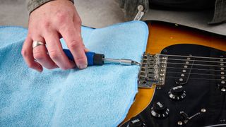 Adjusting the saddles on a guitar