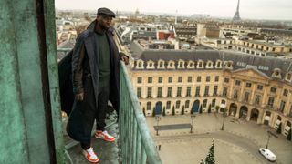 Omar Sy standing on a balcony in Lupin part 3 epsiode 1