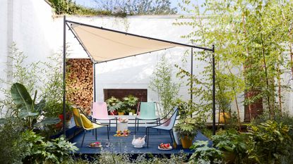 A contemporary sail shade gazebo over a modern garden seating area