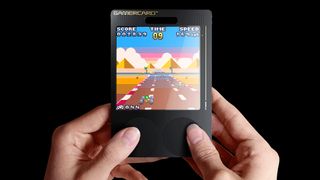 Sinclair GamerCard; hands hold a small black retro game handheld
