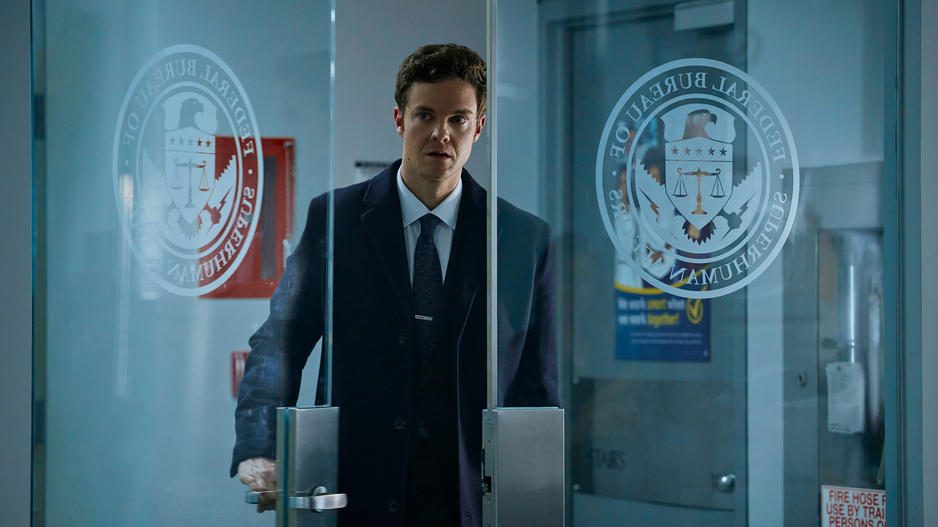 Hughie opens a glass door at the Bureau for Superhuman Affairs in The Boys season 3