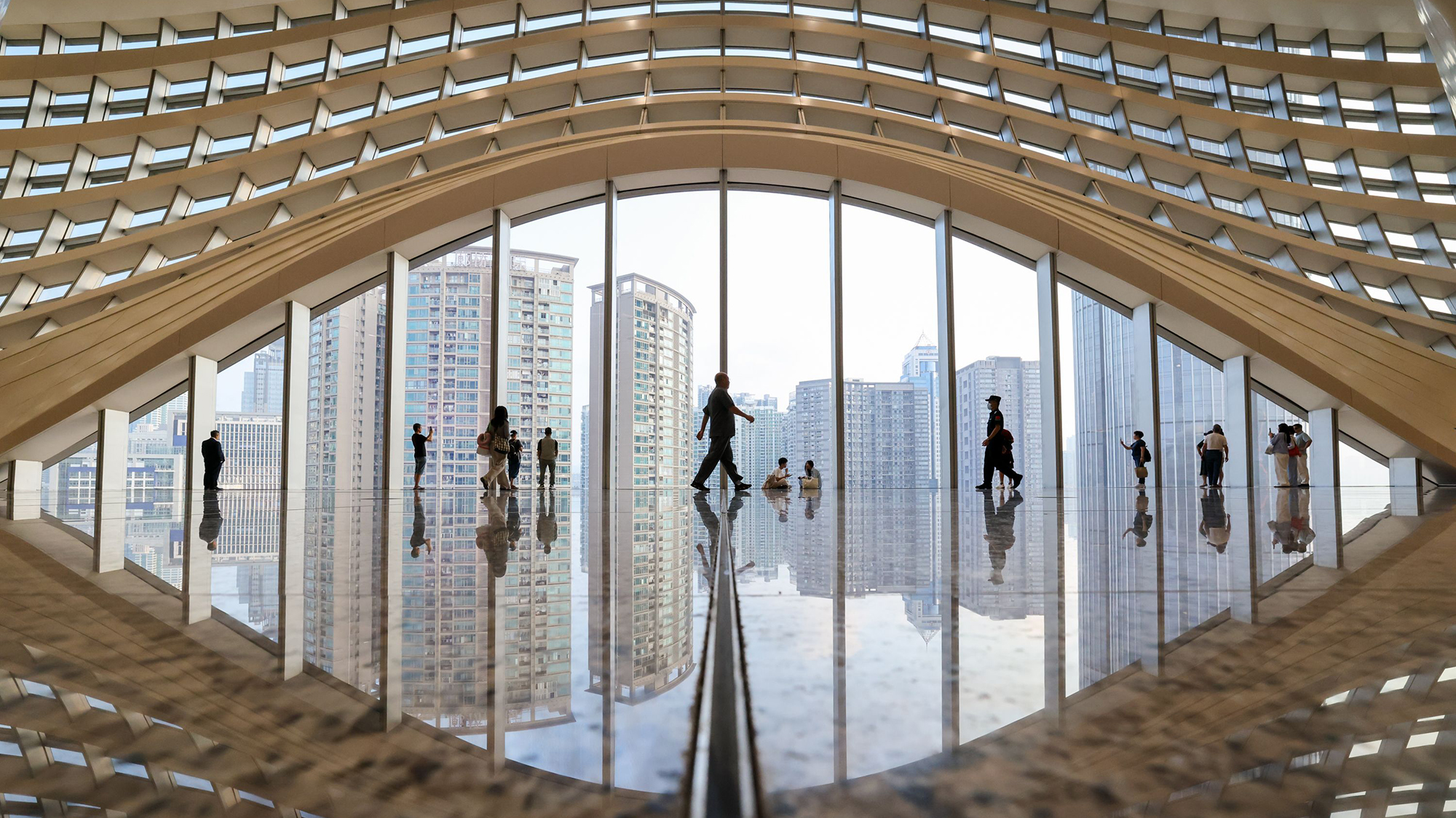 Passengers walk through the departures hall of the newly renovated Huanggang Port in Shenzhen, China