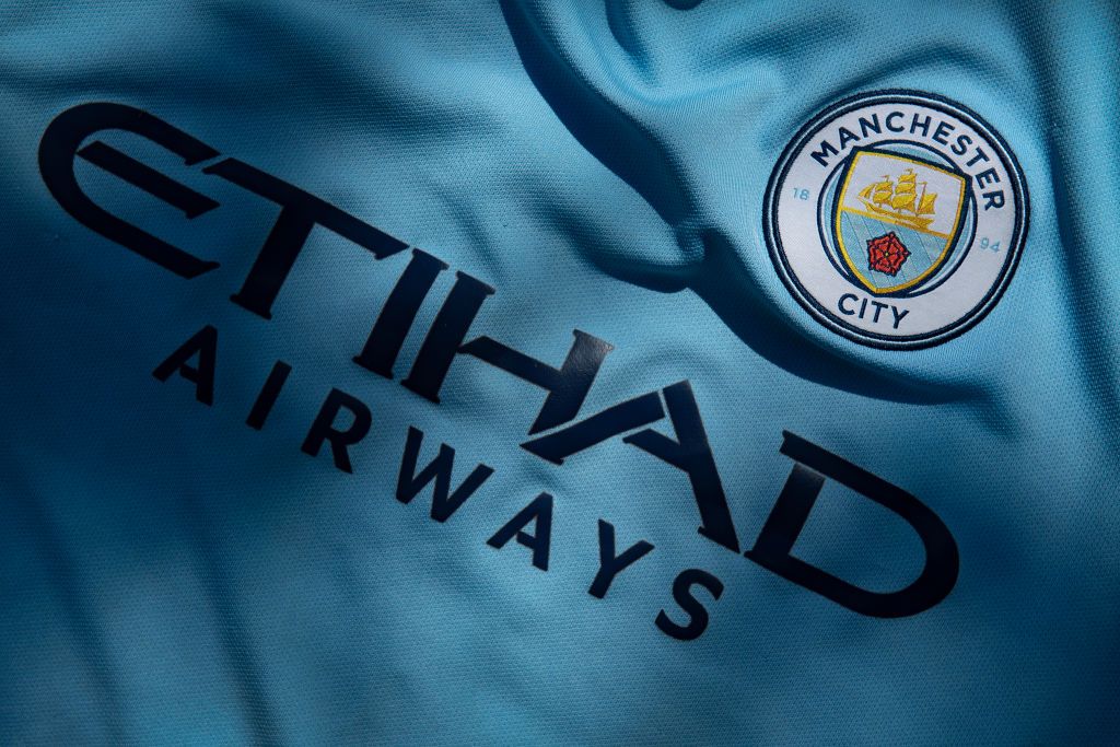 The Manchester City club crest displaying Etihad Airways as the shirt sponsor on a first team shirt on April 24, 2020 in Manchester, England 