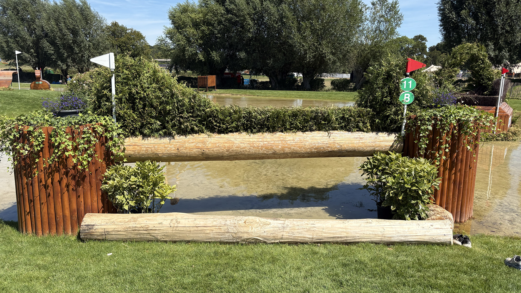 A log with brush on top of it into water on the Aachen eventing World Championships cross-country course